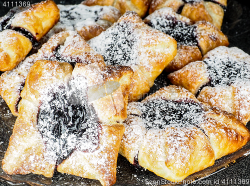 Image of Danish pastry with blueberry jam filling with white powdered sug