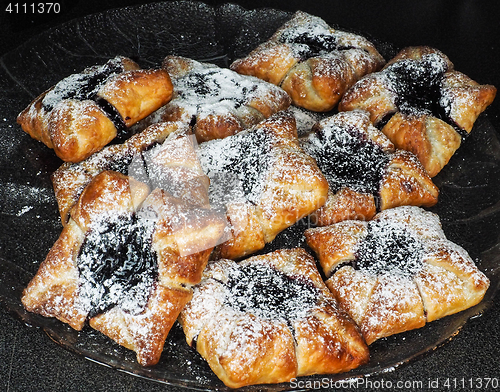 Image of Danish pastry with blueberry jam filling with white powdered sug