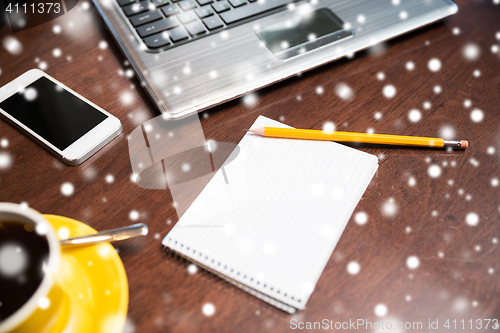 Image of notebook with pencil, smartphone and laptop