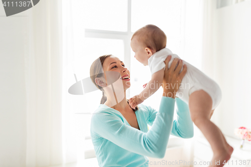 Image of happy young mother with little baby at home