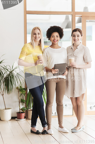 Image of creative team with tablet pc and coffee in office