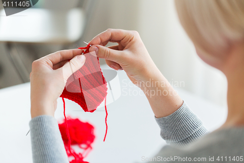 Image of woman hands knitting with needles and yarn