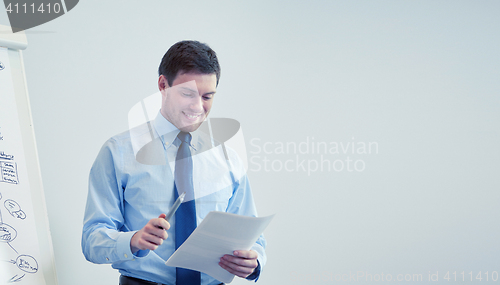 Image of smiling businessman on presentation in office