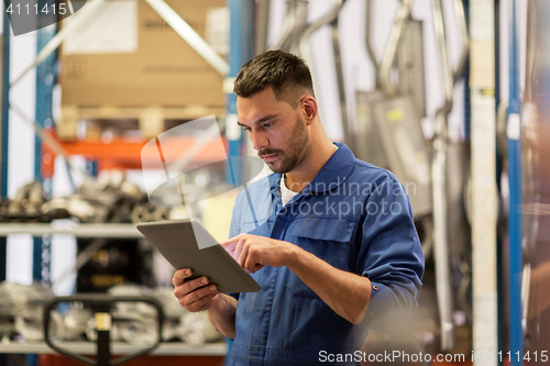 Image of auto mechanic or smith with tablet pc at workshop