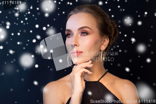 Image of beautiful woman in black wearing diamond jewelry