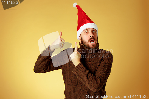 Image of Smiling christmas man wearing a santa hat