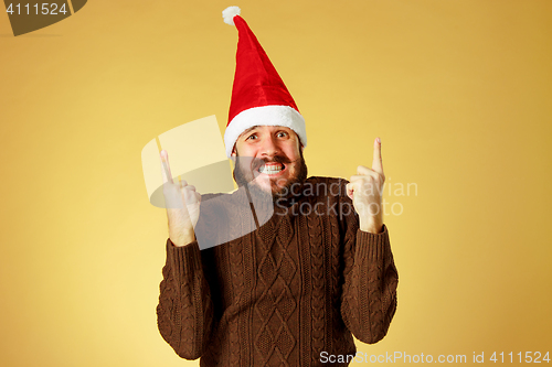 Image of Surprised christmas man wearing a santa hat