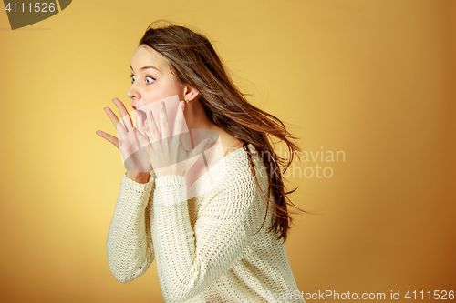 Image of Portrait of young woman with shocked facial expression