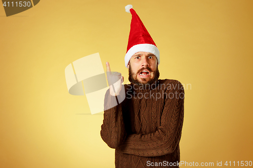 Image of Surprised christmas man wearing a santa hat