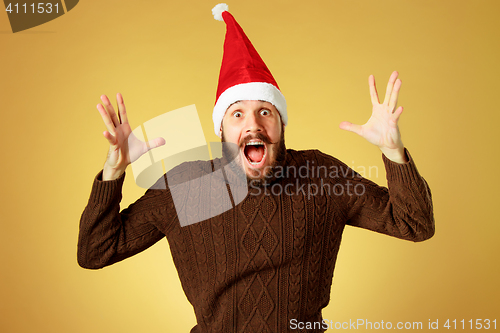 Image of Surprised christmas man wearing a santa hat