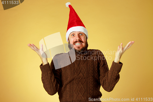 Image of Surprised christmas man wearing a santa hat