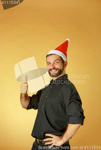 Image of Smiling christmas man wearing a santa hat