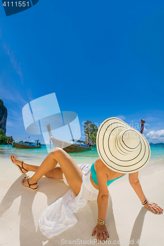 Image of portrait of young pretty woman looking to the ocean 