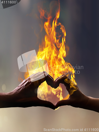 Image of hands with fire in form of heart
