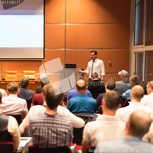 Image of Business speaker giving a talk in conference hall.