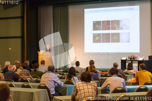 Image of Audience in lecture hall participating at business conference.