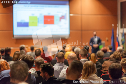 Image of Business speaker giving a talk in conference hall.