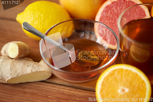 Image of tea with honey, lemon and ginger on wood