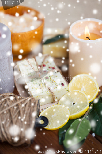 Image of natural soap and candles on wood