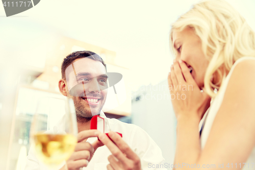 Image of man with engagement ring making proposal to woman