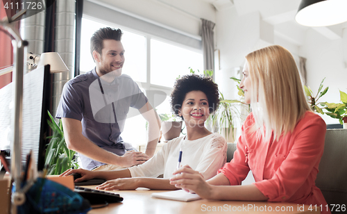 Image of happy creative team in office