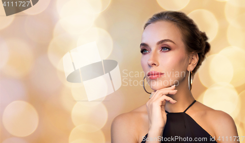 Image of beautiful woman in black wearing diamond jewelry