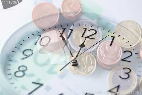 Image of clock over euro money with double exposure