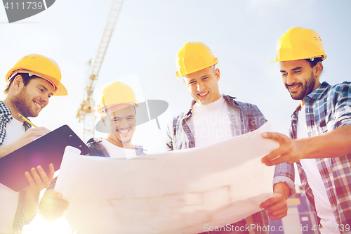 Image of group of builders with tablet pc and blueprint