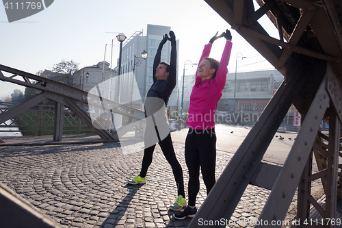 Image of couple warming up before jogging