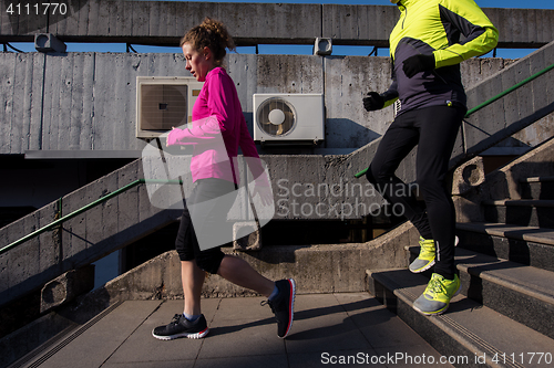 Image of young  couple jogging on steps