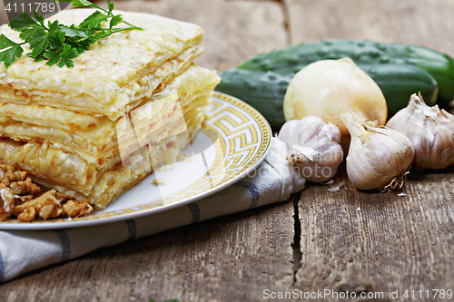 Image of Stack of closed pizza and vegetables