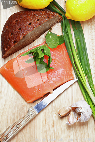 Image of Salmon fish with bread and vegetables