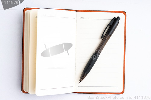 Image of notepad with pen isolated