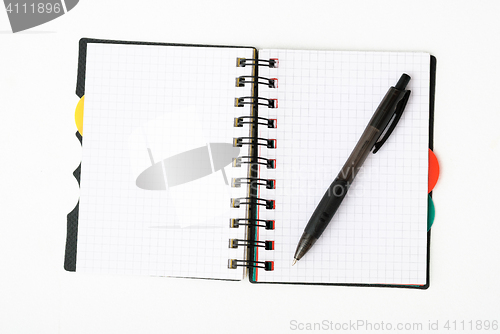 Image of notepad with pen isolated