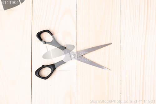 Image of Scissors on wooden background