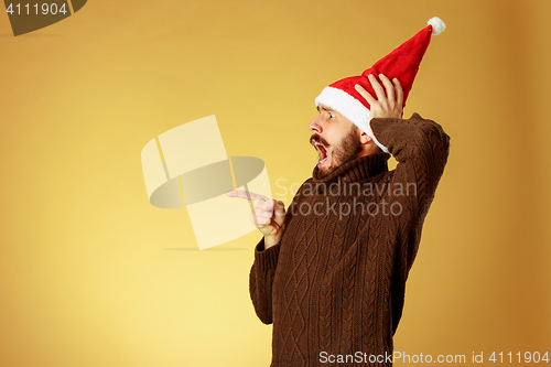 Image of The serious christmas man wearing a santa hat