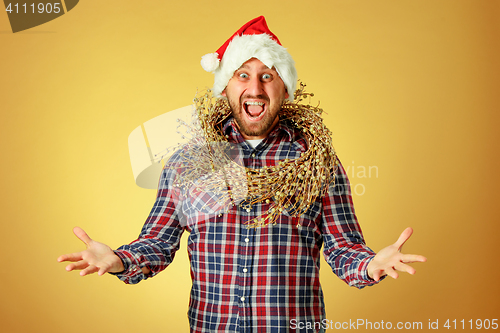 Image of Smiling christmas man wearing a santa hat