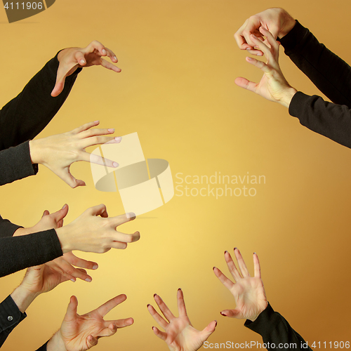 Image of Many hands reaching out up in the air