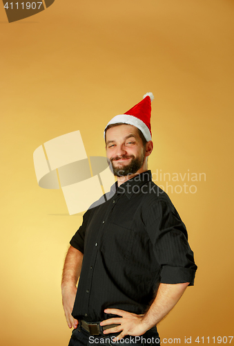 Image of Smiling christmas man wearing a santa hat