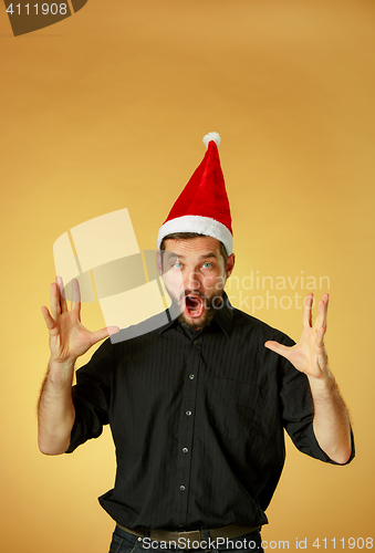 Image of The screaming christmas man wearing a santa hat