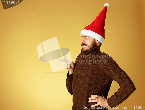 Image of The serious christmas man wearing a santa hat