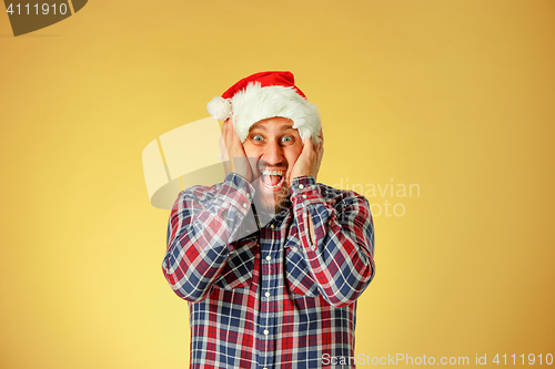 Image of Smiling christmas man wearing a santa hat