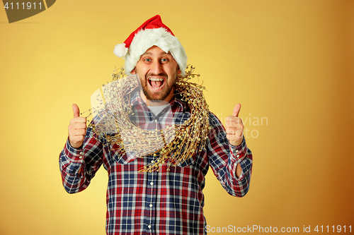 Image of Smiling christmas man wearing a santa hat
