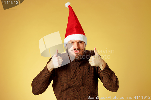 Image of The serious christmas man wearing a santa hat