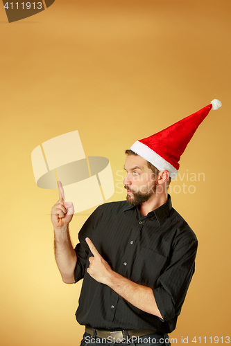 Image of The serious christmas man wearing a santa hat