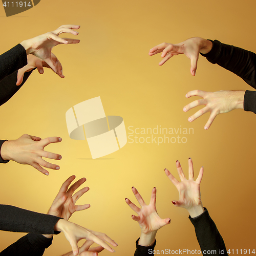 Image of Many hands reaching out up in the air