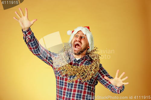 Image of Smiling christmas man wearing a santa hat