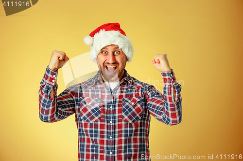 Image of Smiling christmas man wearing a santa hat