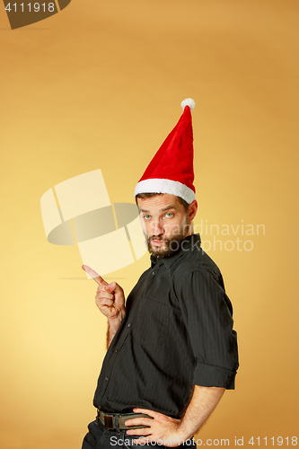 Image of The serious christmas man wearing a santa hat