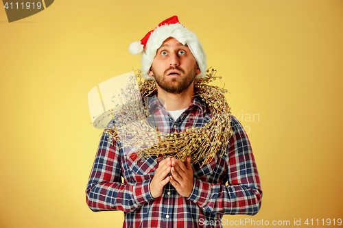 Image of Smiling christmas man wearing a santa hat